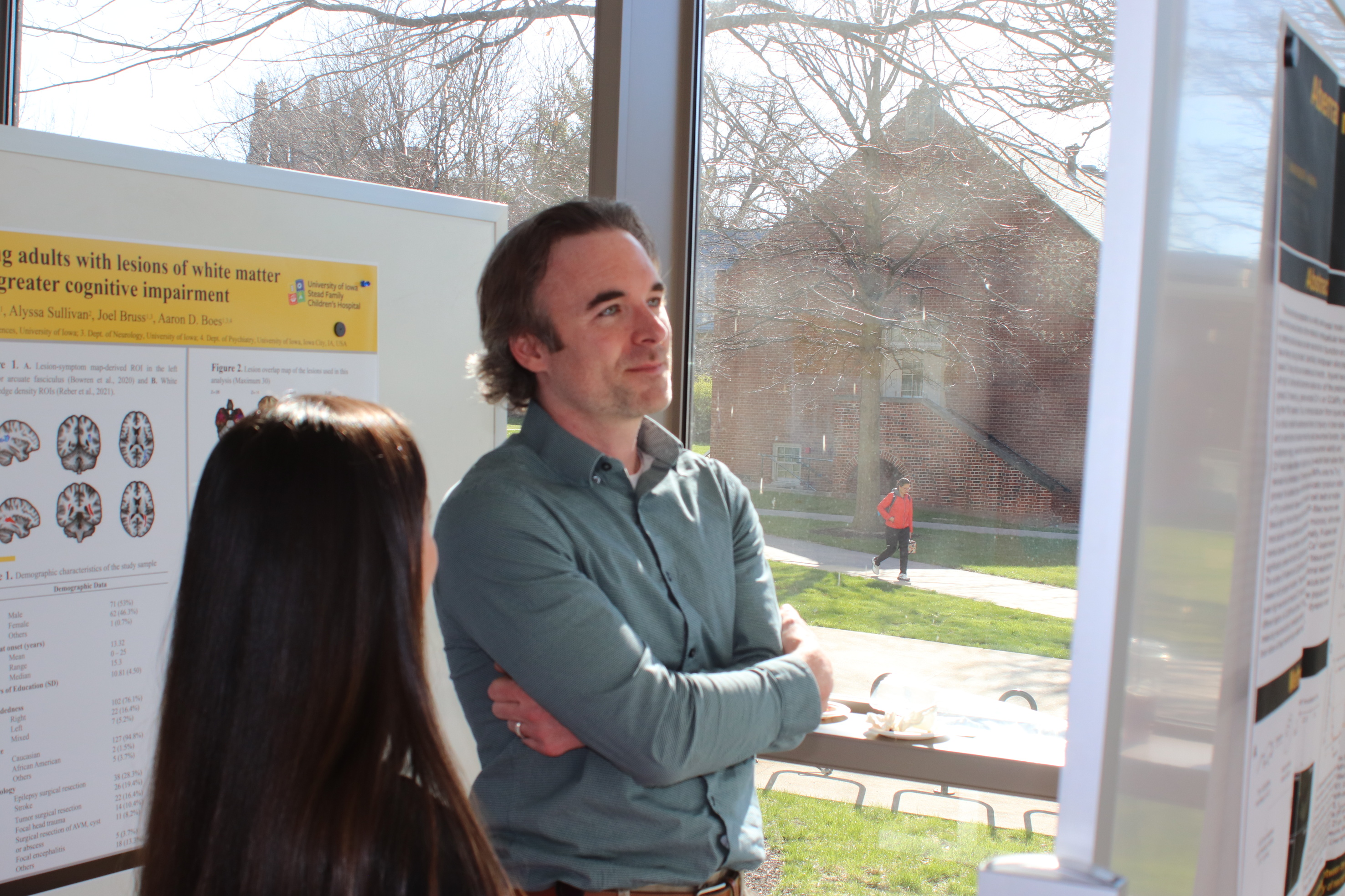 Brandon Rea pondering his poster at Pediatrics Research Day 2024